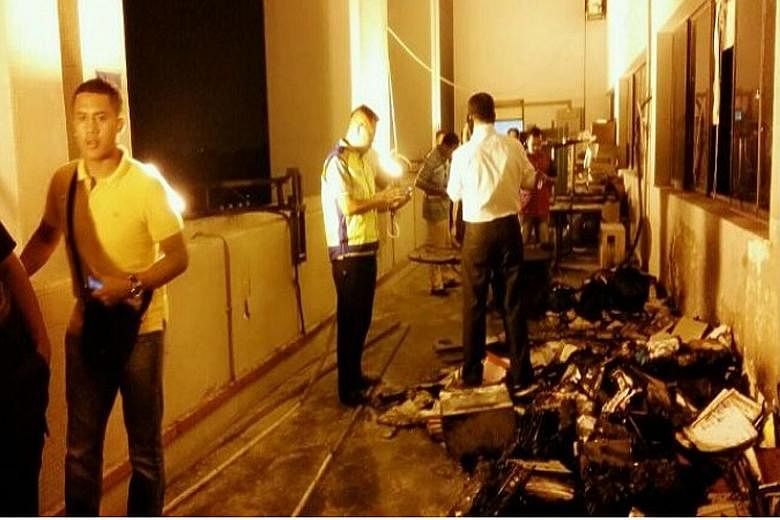 (Left) A picture posted on social media shows the apparent aftermath of the fire on Wednesday at the police headquarters. Police chief Khalid Abu Bakar (above) says only unimportant documents were destroyed in the blaze.