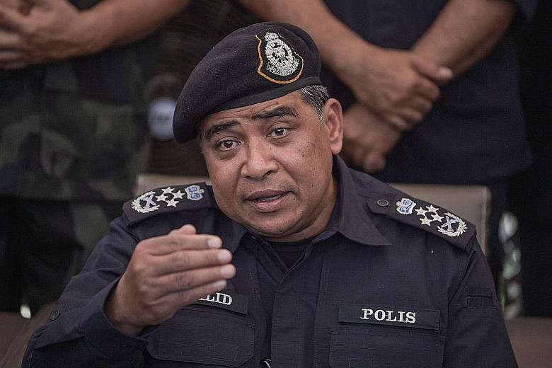 (Left) A picture posted on social media shows the apparent aftermath of the fire on Wednesday at the police headquarters. Police chief Khalid Abu Bakar (above) says only unimportant documents were destroyed in the blaze.