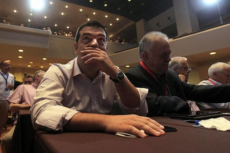 Mr Alexis Tsipras (far left) attending a Syriza party central committee meeting in Athens yesterday in an attempt to settle differences among party members.