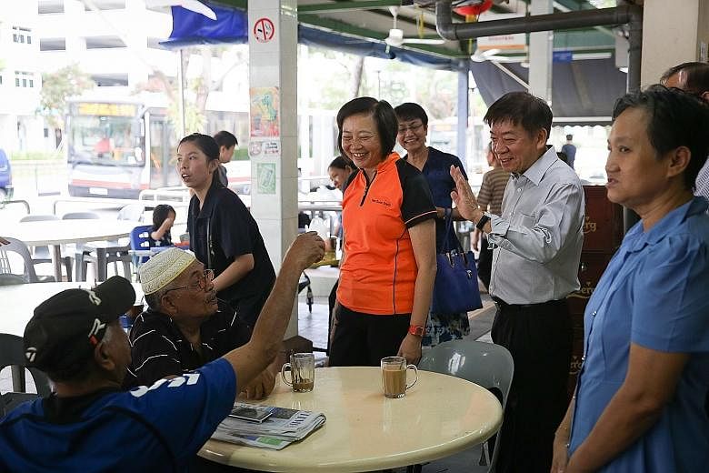 Sembawang GRC MP Khaw Boon Wan (in light shirt) with Nee Soon GRC MP Lee Bee Wah at a coffee shop in Yishun. Right, from top: The other Sembawang GRC members, Ms Ellen Lee and Mr Vikram Nair, will be joined by Dr Lim Wee Kiak and possibly Mr Amrin Am