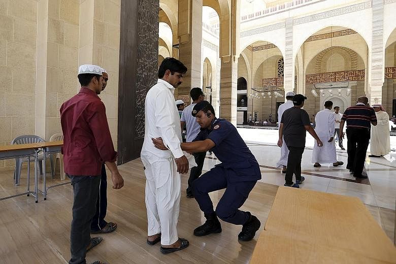 A police officer frisking a man earlier this month at the Bahrain Sunni Grand Mosque, where joint Sunni and Shi'ite Friday prayers were held to show solidarity after ISIS bombings of Shi'ite mosques in Saudi Arabia and Kuwait.