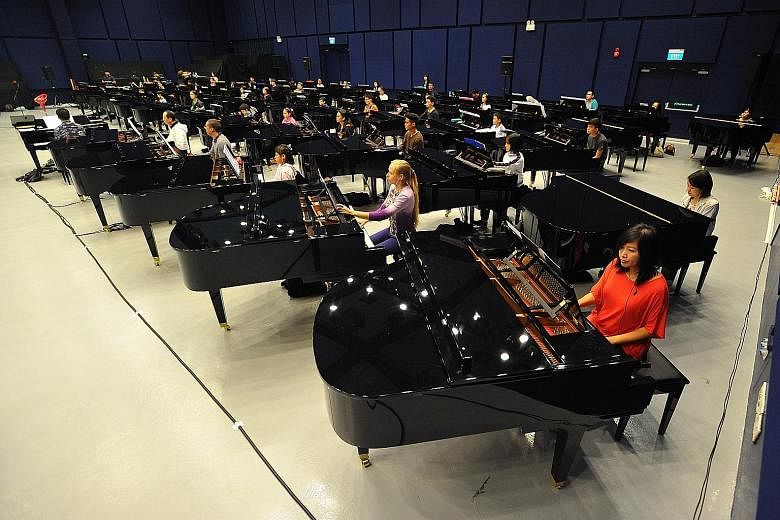Pianists at a rehearsal last month for the Sing50 concert. Insurance group Zurich has pledged to donate $5 for every person who attends the show. Mr Jonathan Rake, chief executive of Zurich's general insurance business in Singapore, encouraged those 