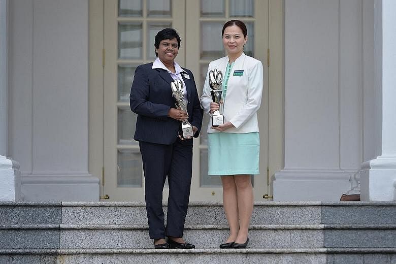 Ms Velusamy Poomkothammal (left), Khoo Teck Puat Hospital's assistant director of nursing, and Dr Lim Su-Fee, a senior nurse clinician at Singapore General Hospital, were among those who received their awards yesterday from President Tony Tan Keng Ya