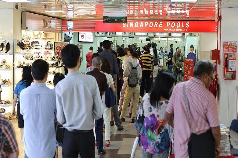 Punters queueing to place bets at a Singapore Pools outlet. A spokesman for the lottery operator said that they would have to study offering self-service kiosks in more detail to see if customers used to counter service for years would be receptive t
