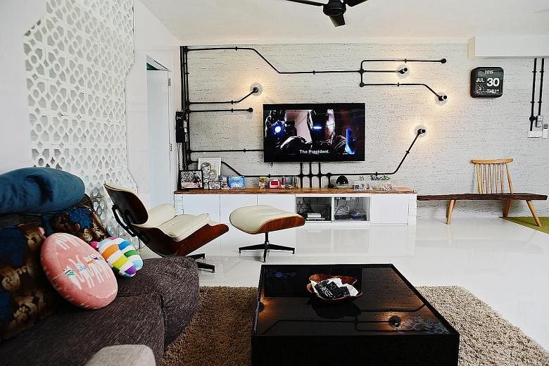 A custom- designed wall with lightbulbs (right) forms the backdrop for the flatscreen television set in the living room. The built-in white wardrobe (above) in the master bedroom. An opening in the wall of the master bathroom (right) allows the user 