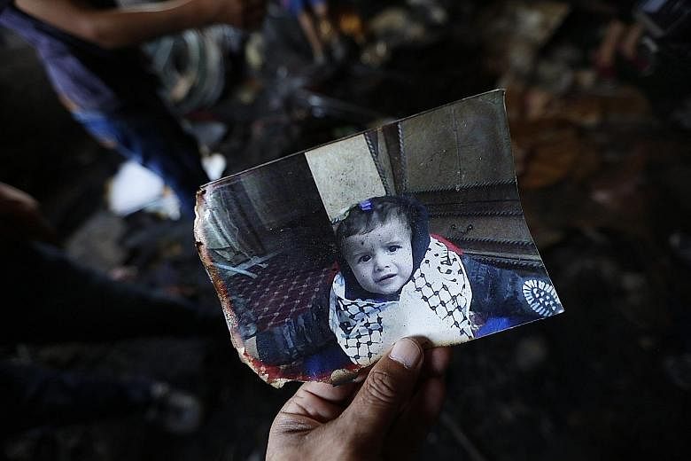 A photograph of 18-month-old Ali Dawabsha who was killed when his home was set alight in the West Bank village of Duma yesterday. Several others were also injured in the attack.