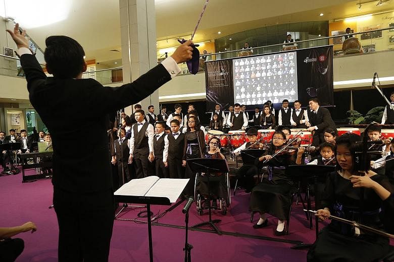 The Purple Symphony, which comprises a Chinese orchestra, strings, Chinese winds, percussion and singers, performing its set of five songs to an enthralled audience of 150 at the Singapore Conference Hall yesterday.