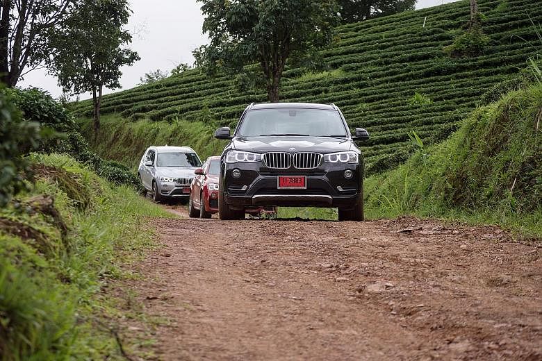 The convoy of BMW X models that the marque calls Sport Activity Vehicles rolling through the mountain roads of Chiang Rai.