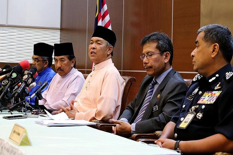 Datuk Seri Ahmad Zahid Hamidi (third from left) at his first press conference as Deputy Prime Minister yesterday, along with police chief Khalid Abu Bakar (right) and officials from the Sabah government and Home Ministry. Mr Zahid said there was no a
