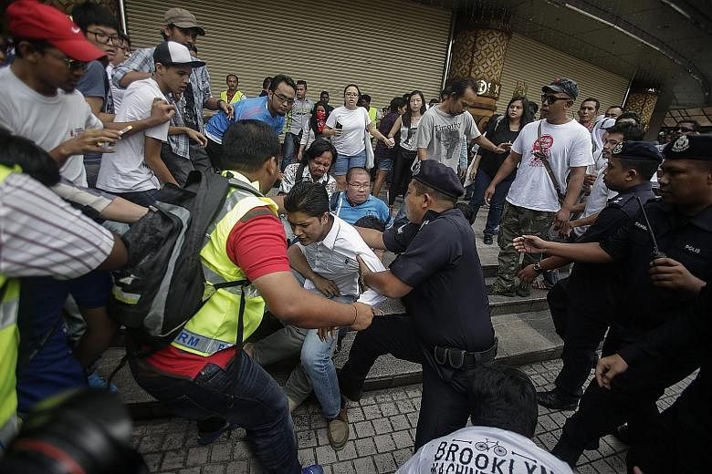 Supporters of the #TangkapNajib (Arrest Najib) protest clashing with the Royal Malaysia Police in Kuala Lumpur yesterday. About 100 people took part in the demonstration.