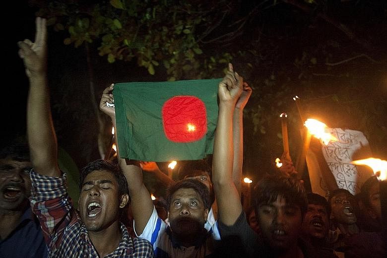 Residents of the Dashiar Chhara enclave, which belonged to India but has become part of Bangladesh, take to the streets in celebration yesterday. The Bangladesh government will roll out a "fast-track masterplan" to develop the enclaves, building new 