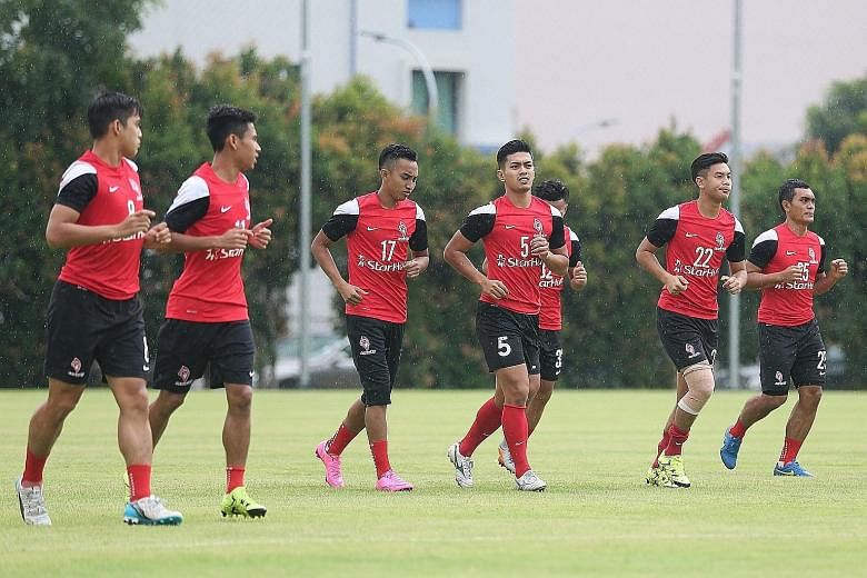 Faris Ramli (third from left, in a LionsXII training session) wants to banish the pain of not doing well in the SEA Games and end the Malaysia Super League season on a high note.