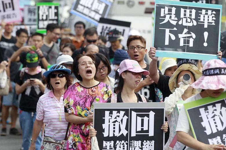 Taiwan Protesters Rip Up Textbooks, Demand Education Minister's ...