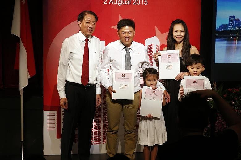 (From left) DPM Teo with new citizens and Pasir Ris-Punggol residents Chong Kuin Sheong, 37; Ke Qi, Mr Chong's six-year-old daughter; wife Chai Yoon Fong, 37; and son Hao Yan, eight.