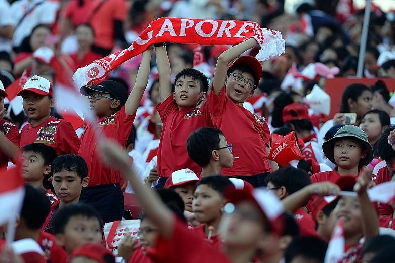 Schoolchildren attending a National Day Parade rehearsal on July 25. PM Lee Hsien Loong noted that the next generation of Singaporeans will be born into a world where the people they identify with need not be geographically close.
