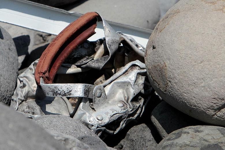 A mangled piece of metal with Chinese characters inscribed on it has been found on La Reunion island. Yesterday, several pieces of debris, one of which was believed by locals to be from a plane door, sparked excitement. However, investigators quickly