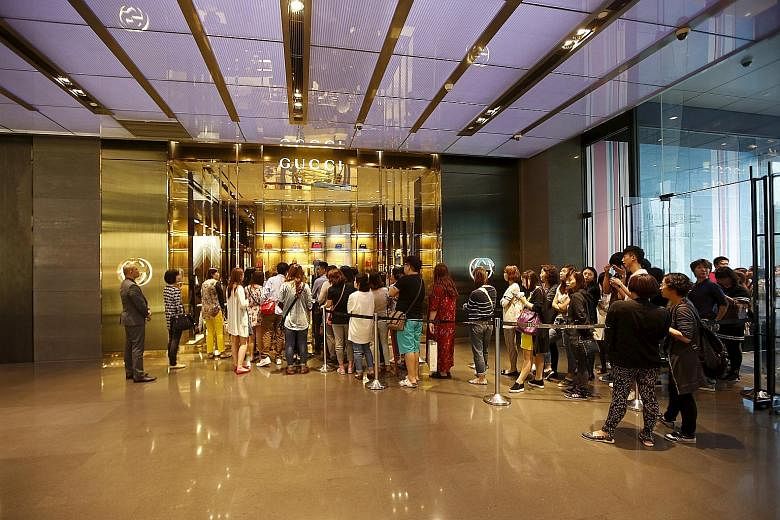 Chinese shoppers with a penchant for prestige goods used to flock to the brands' mainland stores, but the country's slowing economy, austerity measures and a weaker yuan have prompted consumers to watch their spending and head abroad to satisfy their
