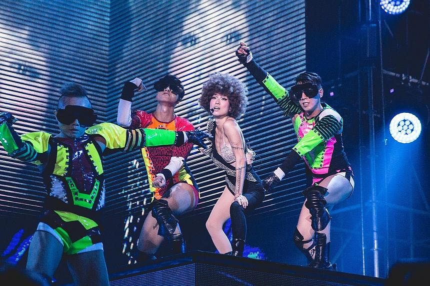 Sammi Cheng sang and danced in costumes that incorporate peekaboo leotards.
