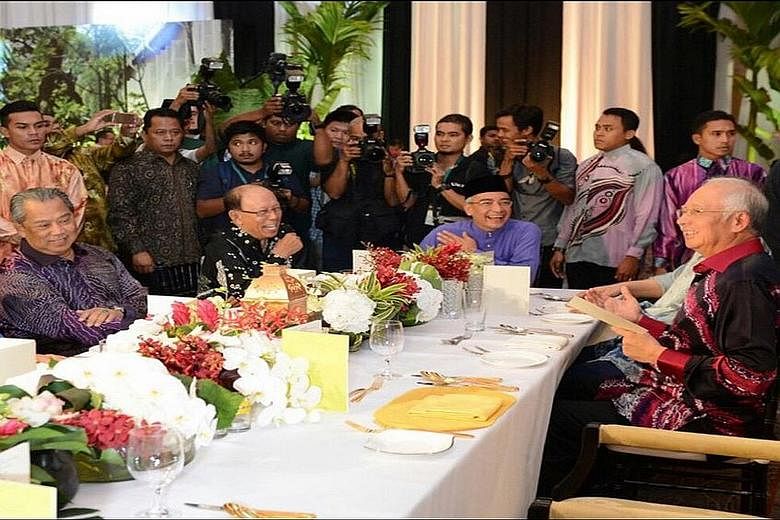 Mr Muhyiddin Yassin (left) and Mr Najib Razak (right) with other guests at a Hari Raya open house hosted by Mr Najib's brother - Nazir (in purple) - last Monday, a day before the PM sacked Mr Muhyiddin.