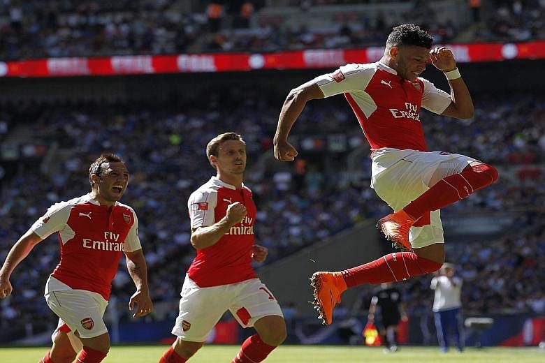 Arsenal's England midfielder Alex Oxlade-Chamberlain (right) celebrates scoring what turned out to be the winning goal in the FA Community Shield against Chelsea.