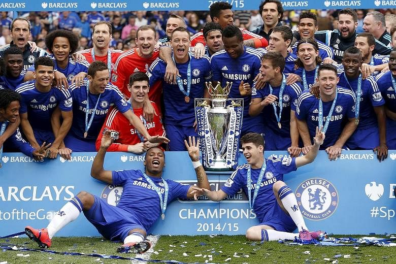 Chelsea celebrating with the Premier League trophy in May. They will aim to become the first side to win back-to-back titles since Manchester United's hat-trick from 2007-09.