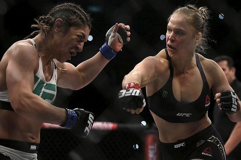 American Ronda Rousey (right) finishing off Bethe Correia in just over half a minute in their UFC bantamweight match in Rio de Janeiro on Saturday. The trash-talking Brazilian had little support from her home crowd as they seemed to know she stood li
