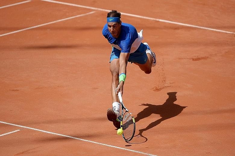 Rafael Nadal stretching to return a mid-court shot against Fabio Fognini. His 67th clay-court title comes after a lean spell this season, both on his favourite clay and in grand slam events.