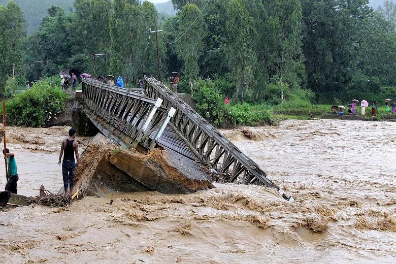 A bridge wrecked by raging floodwaters in Thoubal district in Manipur state yesterday.