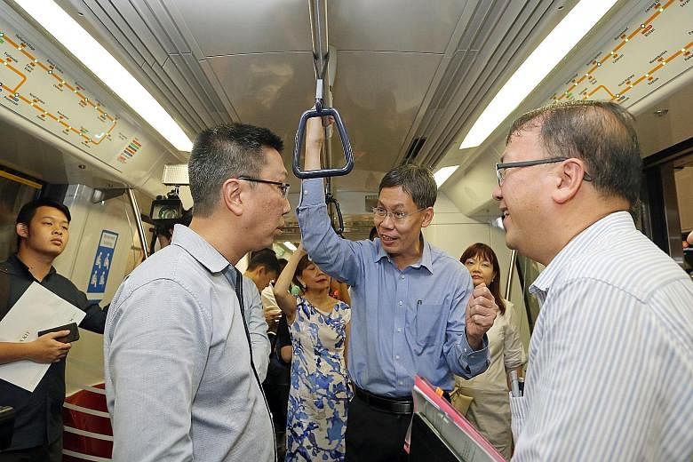 Transport Minister Lui Tuck Yew (centre) with LTA chief executive Chew Men Leong (left) and deputy chief executive for infrastructure and development Chua Chong Kheng riding one of the new trains on the Circle Line yesterday.