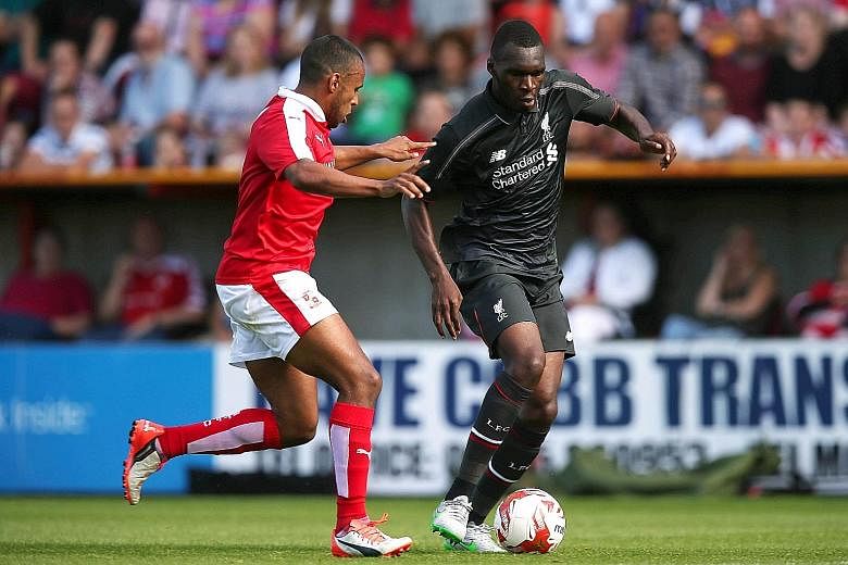 Christian Benteke (right), in action against Swindon, could be the answer to Liverpool's problem of scoring only 52 goals in the EPL last term.
