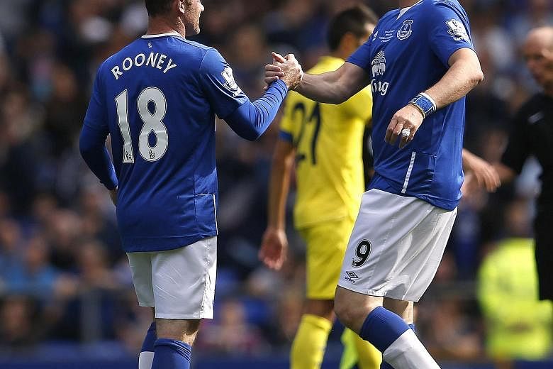 Wayne Rooney (with Everton great Duncan Ferguson, right) said he was a bit apprehensive if the Goodison Park crowd would still be on his side. He started his career at the club before moving to Man United.