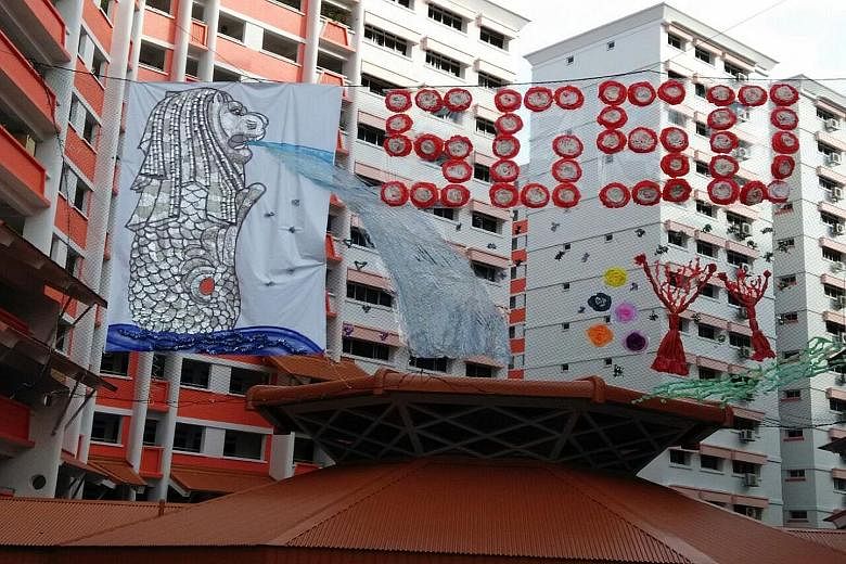A 3D display of a Merlion hanging between blocks 504 and 505 in Choa Chu Kang Street 51. It was made by residents and members of Yew Tee Zone 4 RC out of aluminium foil and other recycled materials.