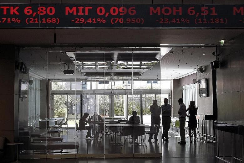 It was a sea of red when the Athens Stock Exchange reopened yesterday, as shown on an electronic board displaying share prices at the bourse in Athens.