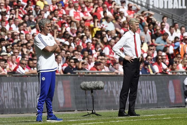 Chelsea manager Jose Mourinho (left) and his Arsenal counterpart Arsene Wenger standing close by as they watch their respective teams play in the Community Shield on Sunday. The two later continued their long-standing squabbles with Mourinho claiming that