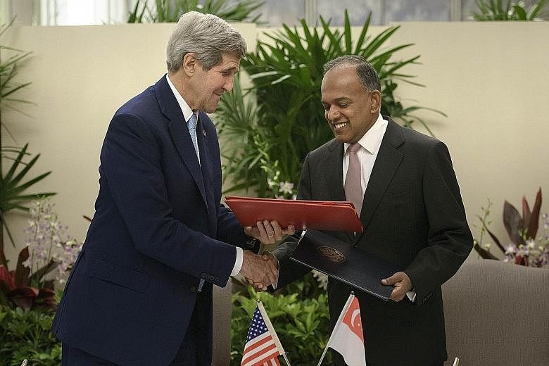 US Secretary of State John Kerry and Foreign Minister K. Shanmugam at the signing of a memorandum of understanding yesterday.