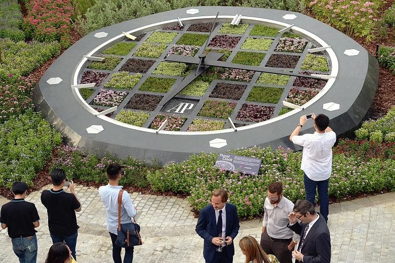 A giant floral clock made up of 5,000 plants was unveiled near the Supertree Grove at Gardens by the Bay yesterday by Minister for National Development Khaw Boon Wan. The 7m-wide timepiece will be refreshed regularly and showcases tropical plants not