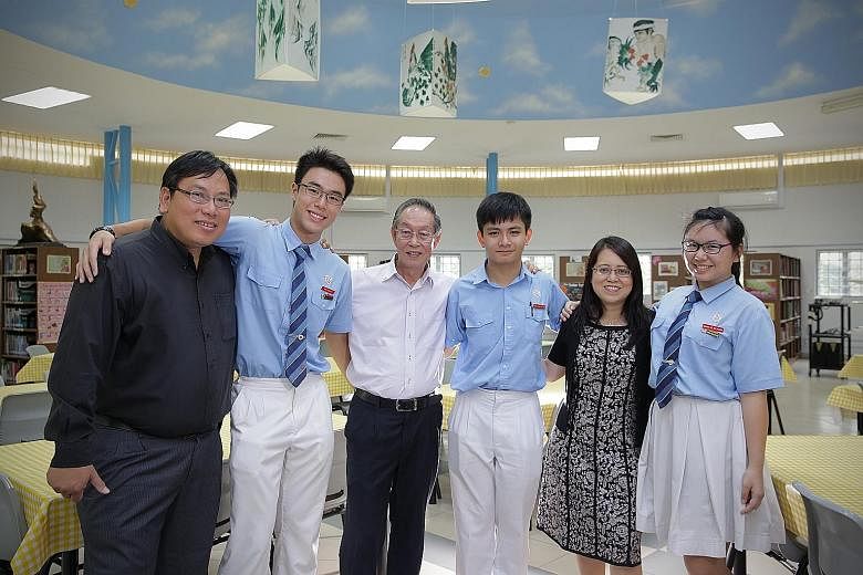 Former student Philip Wu benefited from his school teachers, including Mr Lau Cheong Wong. He now gives back and opens his firm to his juniors for holiday internships. (From left) Mr Wu, student Ong Qing Zhe, Mr Lau, student Vincent Liew, principal W