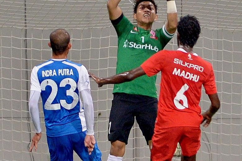 Felda's Indra Putra Mahayuddin (left) beats Izwan Mahbud on Aug 2, before the LionsXII came back to win 2-1 on home soil.