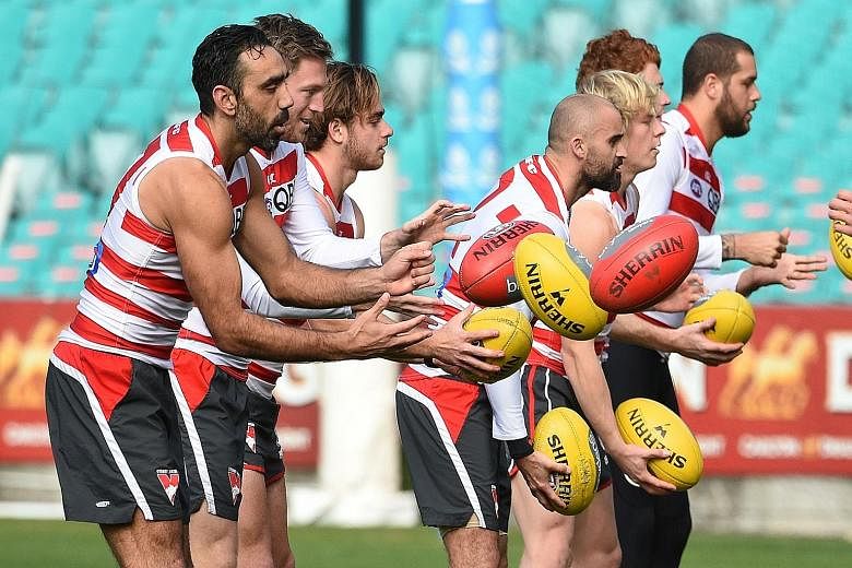 Australian Rules star Adam Goodes (left) at training with Sydney Swans team-mates yesterday. Goodes - an indigenous player and the target of recent racial vilification - said he felt "very loved" after widespread support.