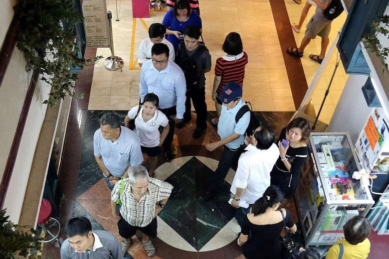 Long queues at moneychangers in Change Alley on June 10 with the ringgit weakening. It has depreciated about 6 per cent against the Singdollar since Jan 1. Some analysts expect it to weaken further.