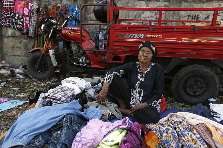 A street vendor waiting for customers near a train station in Jakarta. Domestic spending, such as on clothes, has mostly decreased, and government expenditure used up less than 40 per cent of its budget up to end-June.
