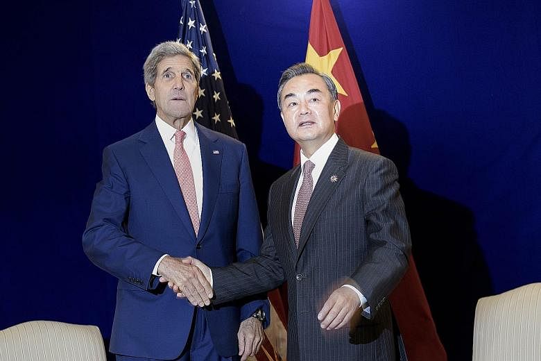 US Secretary of State John Kerry and China's Foreign Minister Wang Yi meeting in Kuala Lumpur yesterday. Mr Wang put forward a three-point proposal for "promoting peace and stability in the South China Sea" at a meeting with Asean foreign ministers.