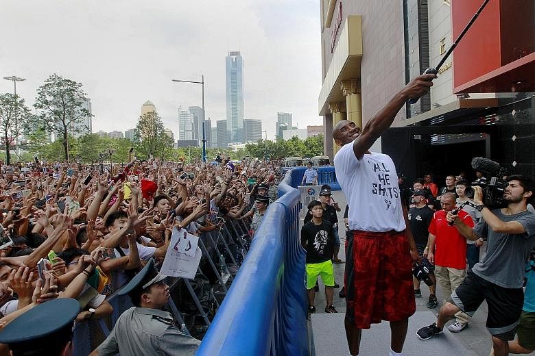 NBA player Kobe Bryant taking a selfie with hordes of fans during a promotional event at a store in Guangzhou, China last Sunday. The 17-time All-Star says that despite injuries in recent seasons, he feels fit for another campaign with the Los Angele