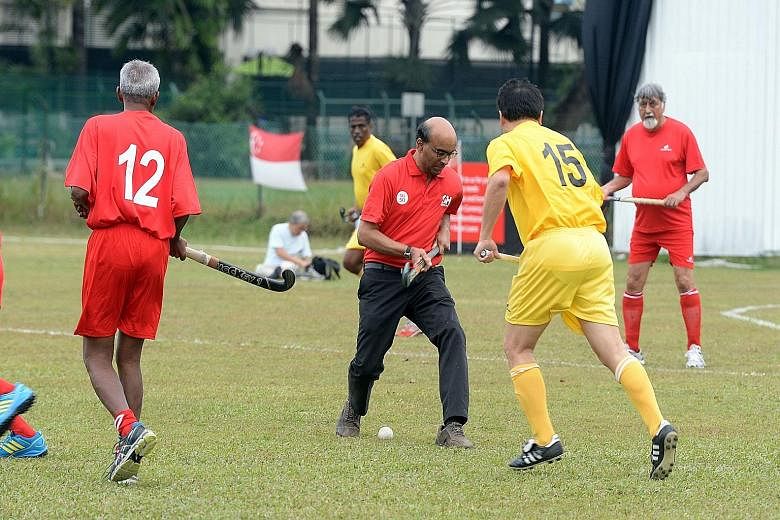 Deputy Prime Minister and Finance Minister Tharman Shanmugaratnam on the ball after bullying off the match between the Singapore ex-internationals and an Indian Association selection to celebrate the Republic's 50 years of independence. In the past 2