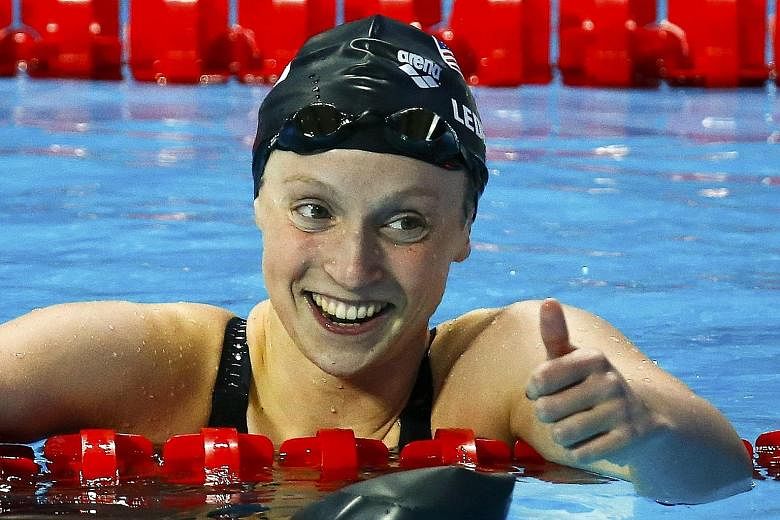 A joyous Katie Ledecky (above) after winning the 200m freestyle and Laszlo Cseh en route to his 200m butterfly victory.