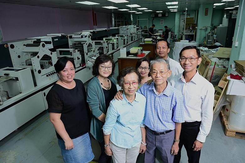 Front row: Winson Press founder Tan Hock Beng and his wife Ong Siew Yong and their son, chief executive Tan Jit Khoon. Behind them are their employees (from left): costing and purchasing manager Jessie Chan, customer service officer Teo Siew Lay, cus