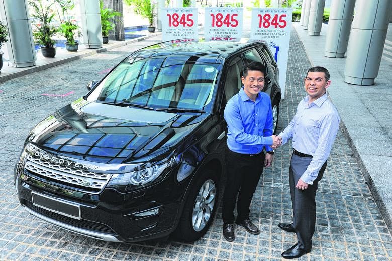 Wearnes Automotive managing director Victor Kwan (at left) handing over a Land Rover Discovery Sport to ST editor Warren Fernandez yesterday. One lucky reader will win the vehicle, which is the ST170 Treats contest's biggest and final prize.