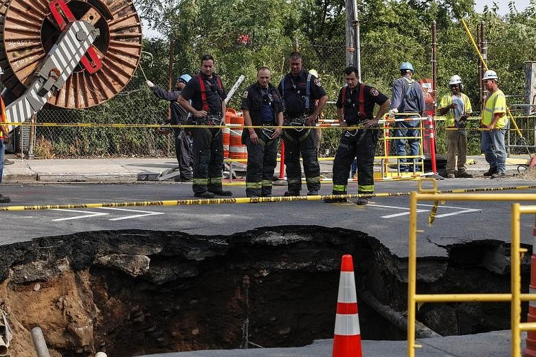 The sinkhole appeared shortly after 7am on Tuesday at an intersection in the area near Sunset Park in Brooklyn, New York. No one was hurt.