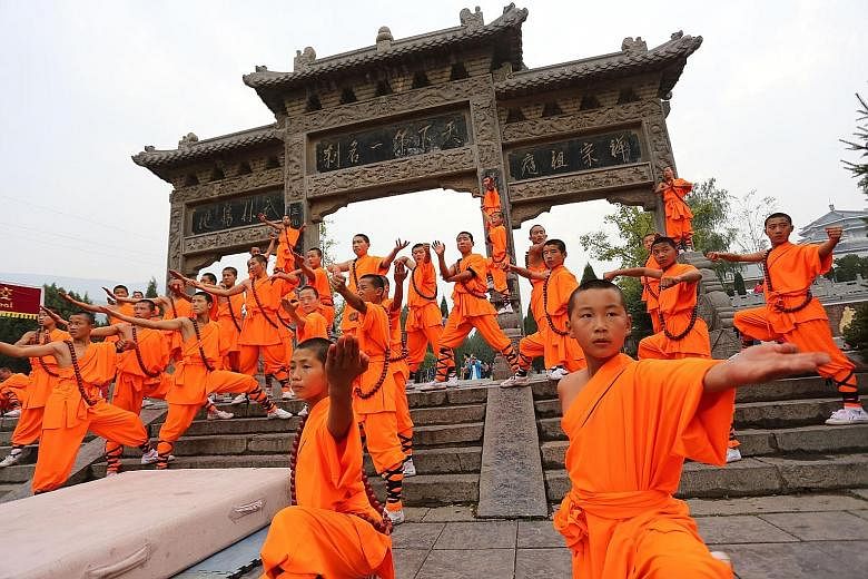 Monks showing off their prowess during the Shaolin International Martial Arts Festival at Shaolin Temple last year. Temple abbot Shi Yongxin is known as China's CEO monk for transforming the monastery into a global commercial empire.
