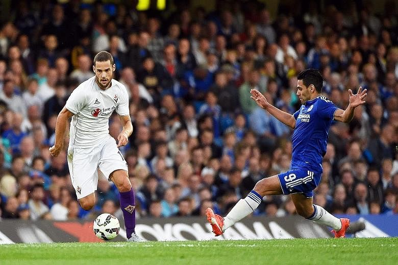 Fiorentina's Mario Suarez (left) and Chelsea's Radamel Falcao vying for the ball. The Colombian's insipid performance has compounded Jose Mourinho's problems.